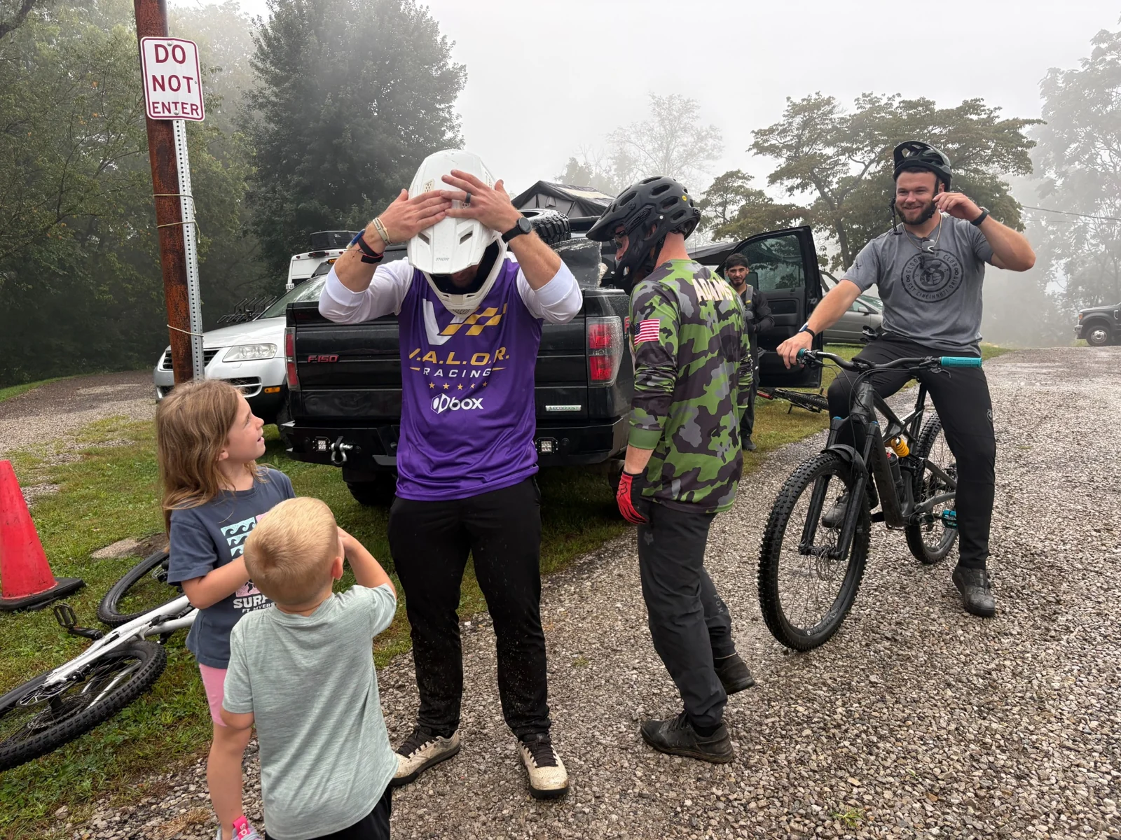 Adults and children gathered beside bicycles after time outside